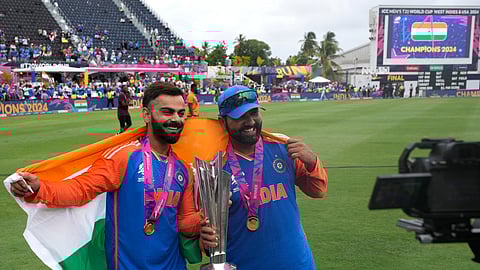 India's Virat Kohli, left, and captain Rohit Sharma pose with the winners trophy after defeating South Africa in the ICC Men's T20 World Cup final cricket match at Kensington Oval in Bridgetown, Barbados, Saturday, June 29, 2024.