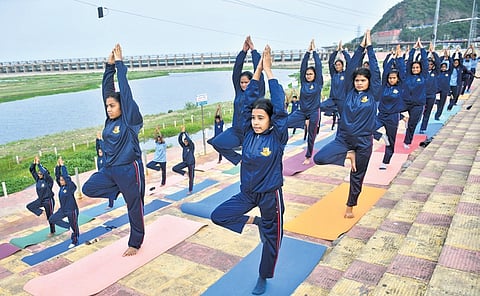 NCC cadets performing yoga asanas on the banks of river Krishna in Vijayawada on Friday