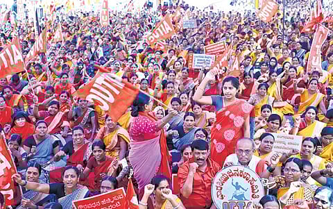 Anganwadi workers stage a protest demanding that the state government start kindergarten classes in anganwadis,in Bengaluru on Monday.