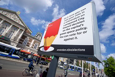 A bicyclist passes a billboard for the European Election opposite the Concertgebouw concert hall Amsterdam, Netherlands, Wednesday, June 5, 2024.