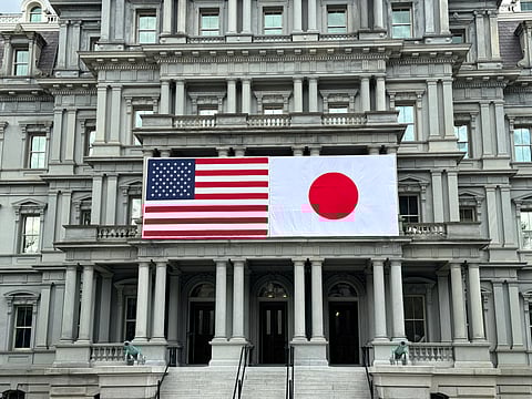 US and Japanese flags are seen posted on the Eisenhower Executive Office Building next to the White House in Washington