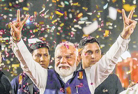 Narendra Modi greets supporters in New Delhi on Tuesday; Congress leaders Rahul Gandhi and Priyanka Gandhi leave after attending a press conference in New Delhi.
