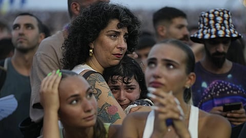 A young woman is comforted as she weeps at the Nova Healing Concert in Tel Aviv, Israel, on Thursday, June 27, 2024.