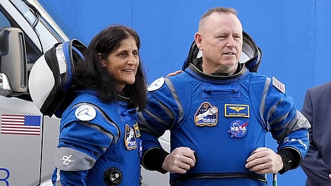 NASA astronauts Suni Williams, Left, and Butch Wilmore talk to family members as they leave the operations and check out building for a trip to launch pad at Space Launch Complex 41, Saturday, JUne 1, 2024, in Cape Canaveral , Fla.