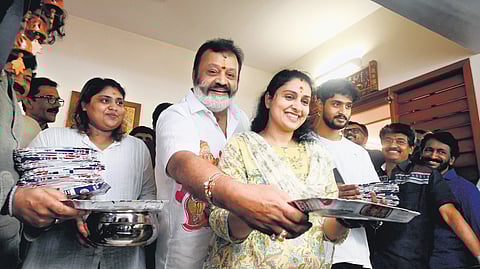 Flanked by wife Radhika, son Madhav & daughter Bhagya, Thrissur MP-elect Suresh Gopi celebrates his victory by distributing payasam to BJP workers and photojournalists at his home.
