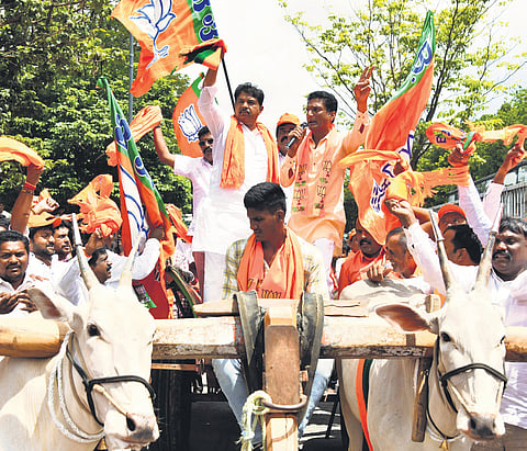 Leader of the Opposition in the Assembly R Ashoka and other BJP leaders drive a bullock cart and protest against the state government, for hiking petrol and diesel prices, in Bengaluru on Monday