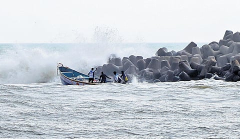 Fishermen braving the rough waves to venture into the sea for fishing at Perumathura Muthalapozhi harbour mouth in Thiruvananthapuram.