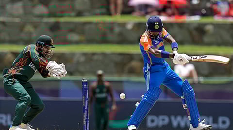 India's Hardik Pandya, right, plays a shot during the ICC Men's T20 World Cup cricket match between India and Bangladesh at Sir Vivian Richards Stadium in North Sound, Antigua and Barbuda, Saturday, June 22, 2024.