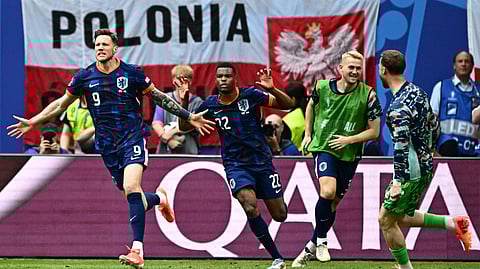 Netherlands' forward #09 Wout Weghorst (L) celebrates scoring his team's second goal next top Netherlands' defender #22 Denzel Dumfries (C) and Netherlands' defender #03 Matthijs De Ligt during the UEFA Euro 2024 Group D football match between Poland and the Netherlands at the Volksparkstadion in Hamburg on June 16, 2024.