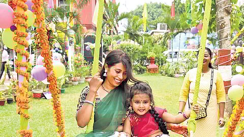 A woman and her daughter enjoying rides on a swing on the eve of Raja festival at Pantha Nivas in Bhubaneswar on Thursday