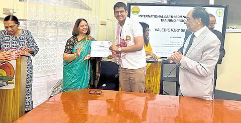 Hema Achyuthan, national coordinator of Earth Science Olympiad, giving away the award to Siddharth Kumar Gopal in Shillong