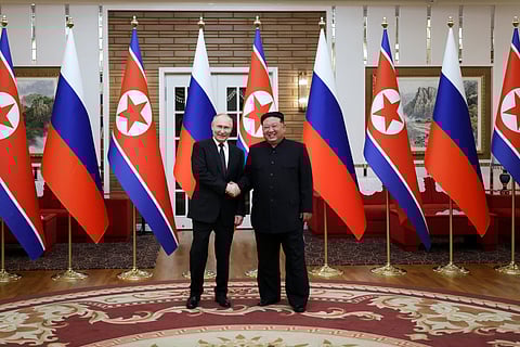 Russian President Vladimir Putin, left, and North Korea's leader Kim Jong Un pose for a photo after the official welcome ceremony in Pyongyang, North Korea.