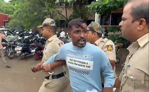 Gangster Jayesh Pujari being taken away to APMC police station from Court premises after shouting pro-Pakistan slogans, in Belagavi on Wednesday.