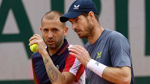Britain's Andy Murray, right, and Britain's Daniel Evans, left, talk strategy during their men's doubles match of the French Open tennis tournament against Brazil's Thiago Seyboth Wild and Argentina's Sebastian Baez