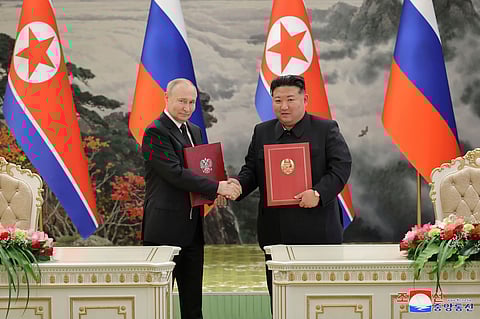 In this photo provided by the North Korean government, North Korean leader Kim Jong Un, right, and Russia's President Vladimir Putin shake hands after signing a comprehensive strategic partnership in Pyongyang, North Korea Wednesday, June 19, 2024.