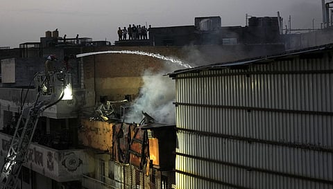 Firefighters douse a fire which broke out at Marwadi Katra in Chandni Chowk, Delhi, Thursday, June 13, 2024.