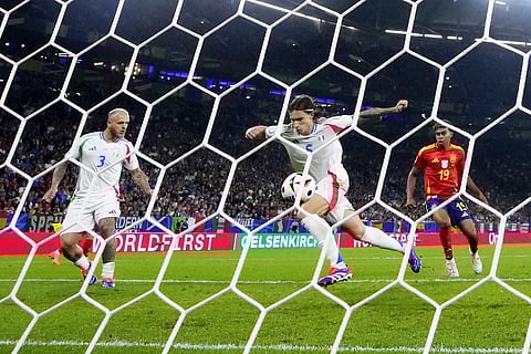Riccardo Calafiori, front, scores an own goal during a Group B match between Spain and Italy at the Euro 2024 soccer tournament in Gelsenkirchen, Germany, Thursday, June 20, 2024.