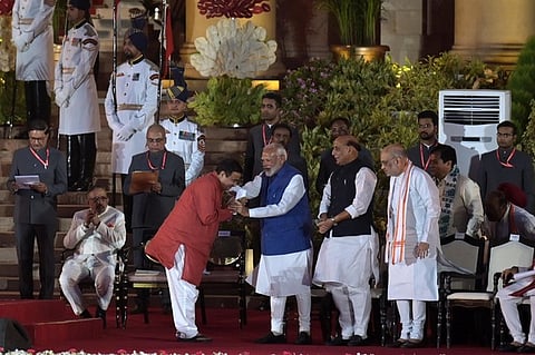 Nitin Gadkari greets Prime Minister Narendra Modi Rajnath Singh and Amit Shah look on at the swearing-in ceremony of the new government.