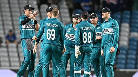 New Zealand's Mitchell Santner (2nd L, hidding) celebrates with teammates after dismissing Uganda's Ronak Patel during the ICC men's Twenty20 World Cup 2024 group C cricket match between New Zealand and Uganda on June 15, 2024.