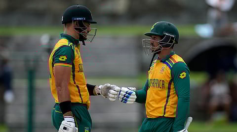 South Africa's captain Aiden Markram, left, fist bumps with batting partner Quinton de Kock during the ICC Men's T20 World Cup cricket match between the United States and South Africa at Sir Vivian Richards Stadium in North Sound, Antigua and Barbuda, Wednesday, June 19, 2024.