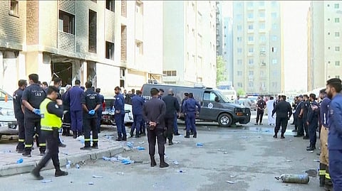 Rescuers arrive at the site of a building that caught fire in Kuwait, Wednesday, June 12, 2024. At least 41 people died when a fire swept through a building that housed workers in Kuwait early Wednesday, and officials said the blaze appeared to be linked to code violations.