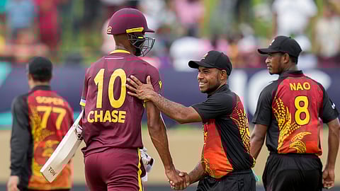 Papua New Guinea's Sese Bau congratulates West Indies' batsman Roston Chase after their ICC Men's T20 World Cup cricket match at Guyana National Stadium in Providence, Guyana, Sunday, June 2, 2024.