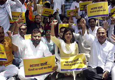 Aam Aadmi Party supporters holding placards, raise slogans during a protest outside Haryana Bhawan over water shortage in the national capital