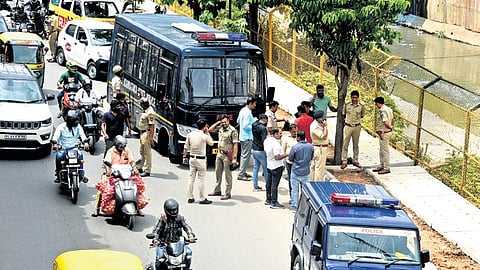 Police take four of the accused for spot mahazar at the stormwater drain, where the victim’s body was found, in Sumanahalli on Wednesday