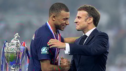 French President Emmanuel Macron greets PSG's Kylian Mbappe during the presentation ceremony after the French Cup final soccer match between Lyon and PSG at the Pierre Mauroy stadium in Villeneuve d'Ascq, northern France, Saturday, May 25, 2024.