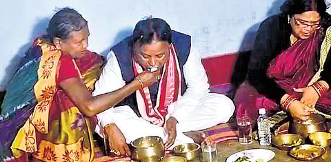 CM Mohan Charan Majhi’s mother feeds him at his house in Keonjhar.