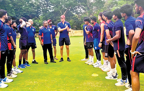 Former Australian legend Glenn McGrath (C) with MRF Pace Foundation chief coach M Senthilnathan (5th from left) with the bowlers during a training session.