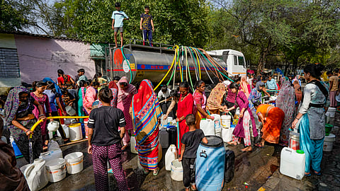 Residents fill water from a tanker amid water crisis, at the Vivekanand Camp, Chanakyapuri area, in New Delhi