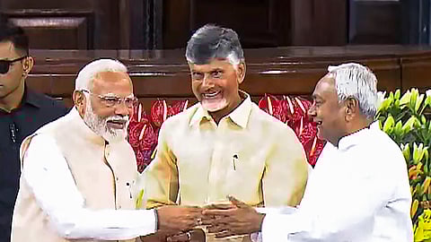 Senior BJP leader Narendra Modi with TDP chief N. Chandrababu Naidu and Bihar CM and JD(U) leader Nitish Kumar during the NDA parliamentary party meeting at Samvidhan Sadan.