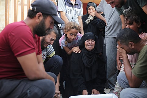 A Palestinian family mourns a loved one killed by Israeli bombardment , as they take a last look before their funeral in Khan Younis, southern Gaza Strip, Friday, June 21, 2024.