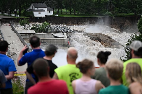 A home teeters on the brink of collapsing into the Blue Earth River on Monday, June 24, 2024, near the Rapidan Dam in Mankato, Minn.