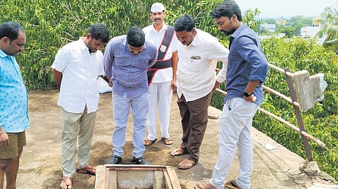 Officials inspecting an overhead water tank in Samalkot.