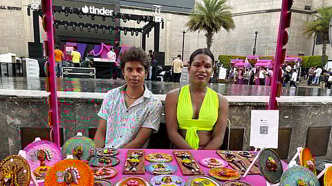 (Right) Karnika Bai, a transwoman mural artist at her stall