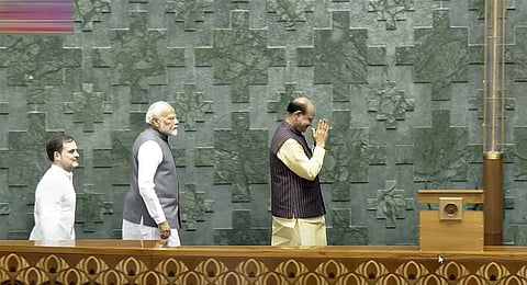 rime Minister Narendra Modi and Leader of the Opposition Rahul Gandhi escort Om Birla to the chair after the latter was elected as the Speaker of the House during the first session of the 18th Lok Sabha, in New Delhi, Wednesday, June 26, 2024.