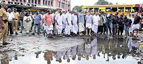 Transport Minister K B Ganesh Kumar and other officials inspect a waterlogged area at the KSRTC bus stand on Saturday