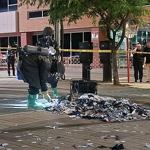 South Korean military officers check unidentified objects believed to be North Korean trash from balloons that crossed the inter-Korea border, on a street in Seoul.