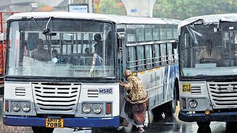 A woman boards a TGSRTC bus in Hyderabad