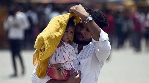 Commuters braving heatwaves during a hot summer afternoon in Delhi