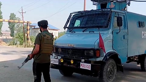A security personnel stands guard after an encounter broke out between security forces and militants, in Pulwama district.