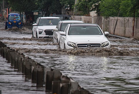 Vehicles move through waterlogged Delhi-Gurugram Expressway.