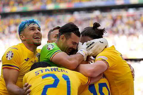 Romania's Razvan Marin is congratulated after scoring his side's 2nd goal during a Group E match between Romania and Ukraine at the Euro 2024 soccer tournament in Munich, Germany, Monday, June 17, 2024.