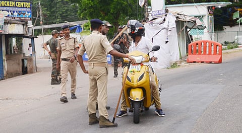 A policeman stopped a motorist during the curfew on Chandipur main road in Balasore on Tuesday.