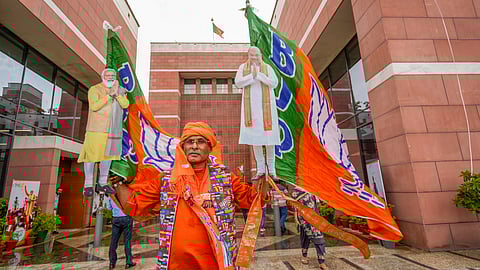 A BJP supporter during the celebration of the party's lead amid the counting of votes for the Lok Sabha elections, at the party office, in New Delhi, Tuesday, June 4, 2024.