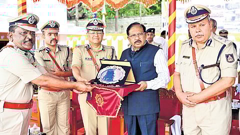 Home Minister Dr G Parameshwara felicitates Shivashankar (extreme left), Director, Karnataka Fire & Emergency Services Department, in Bengaluru on Tuesday.