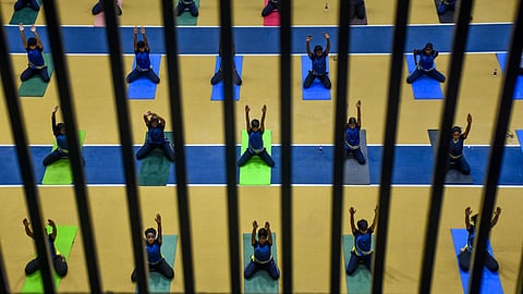Children practicing yoga at Kalinga Stadium in Bhubaneswar on Thursday.