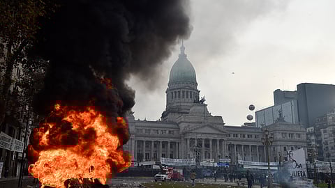 A car burns during clashes between police and anti-government protesters outside Congress, where lawmakers debate a reform bill promoted by Argentine President Javier Milei in Buenos Aires, Argentina, Wednesday, June 12, 2024.
